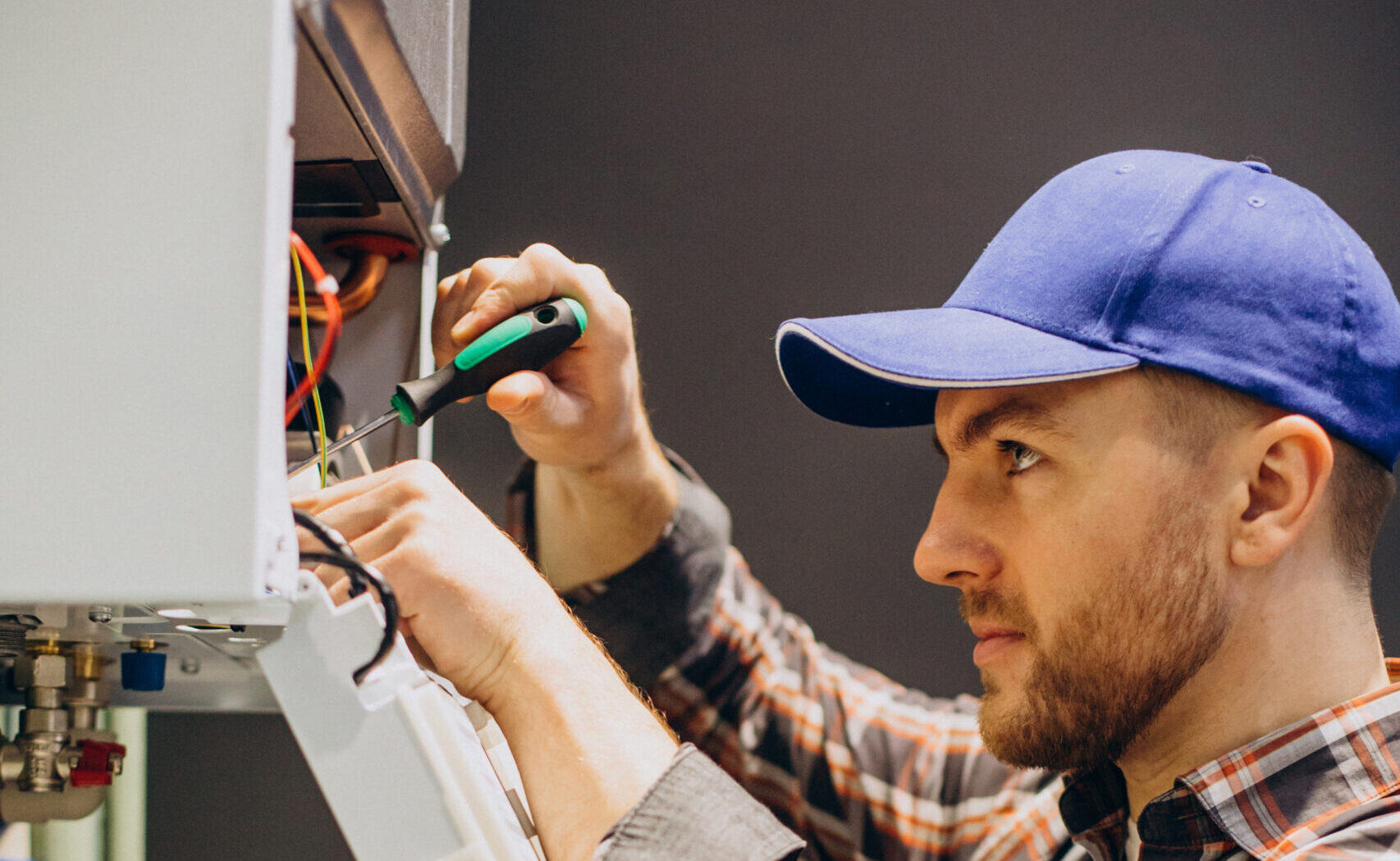 Service man adjusting house heating system